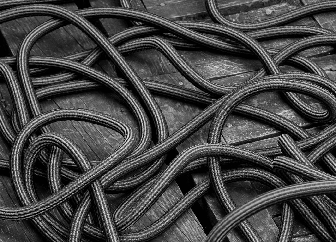 Tangled coils of cable in black and white