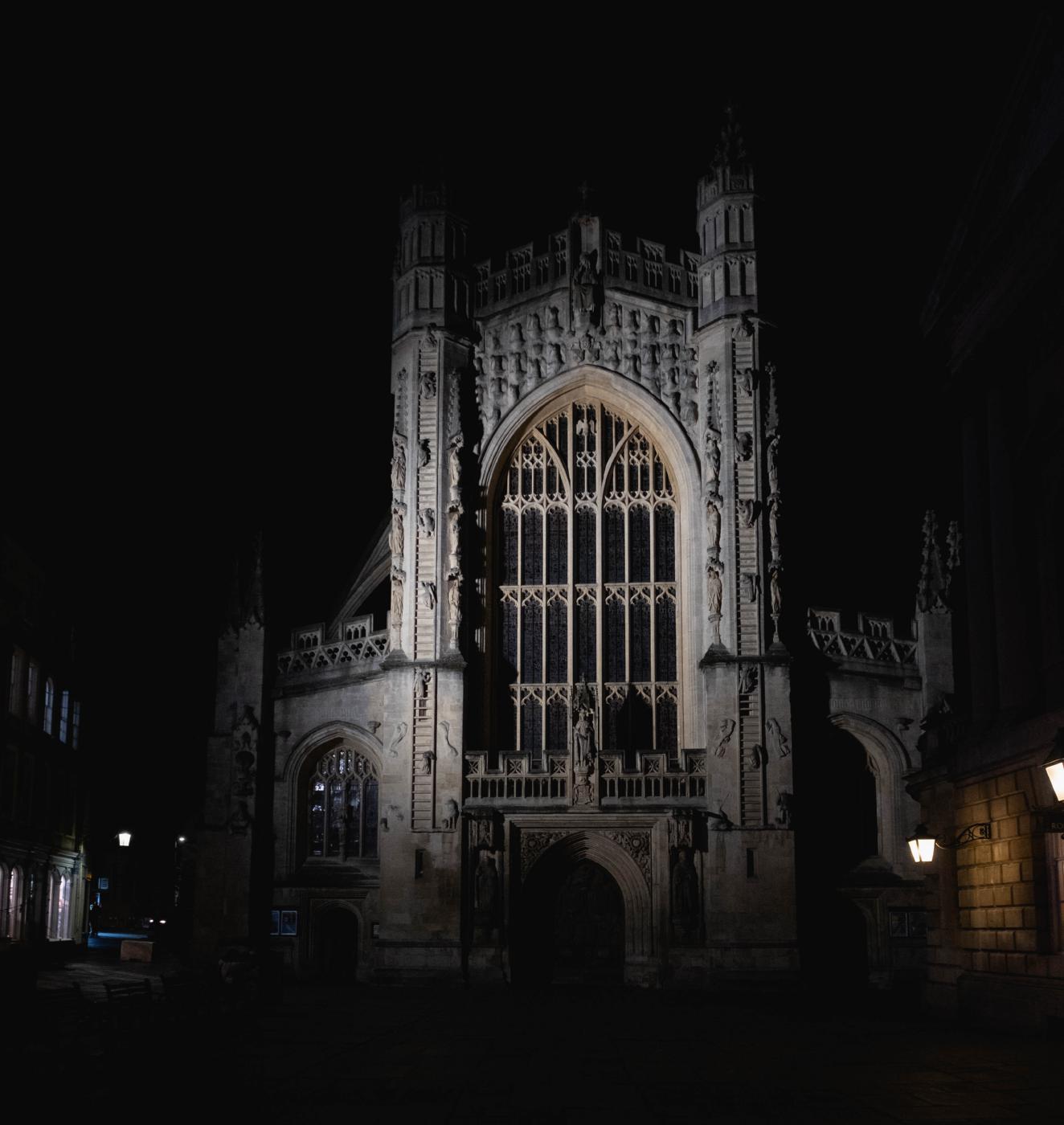 Gothic abbey front lit up at night