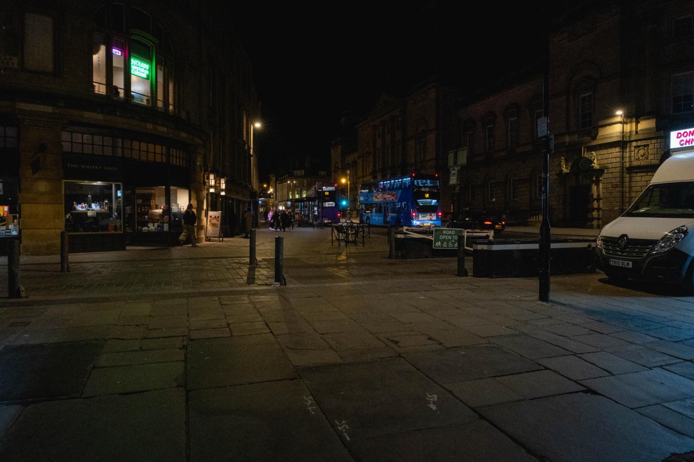 Quiet town street under streetlights at night