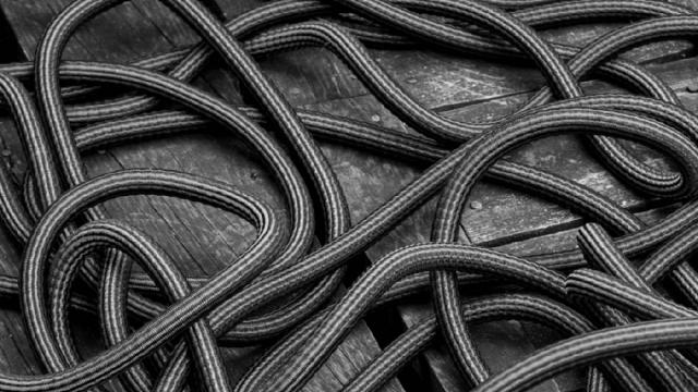 Close-up of tangled cables, in black and white